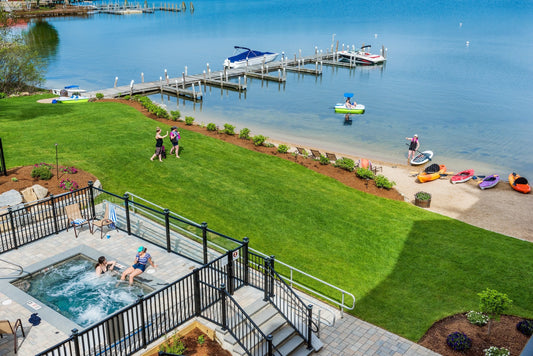 Aerial view of the Center Harbor Inn lawn, sandy beach, docks and kayaks on Lake Winnipesaukee