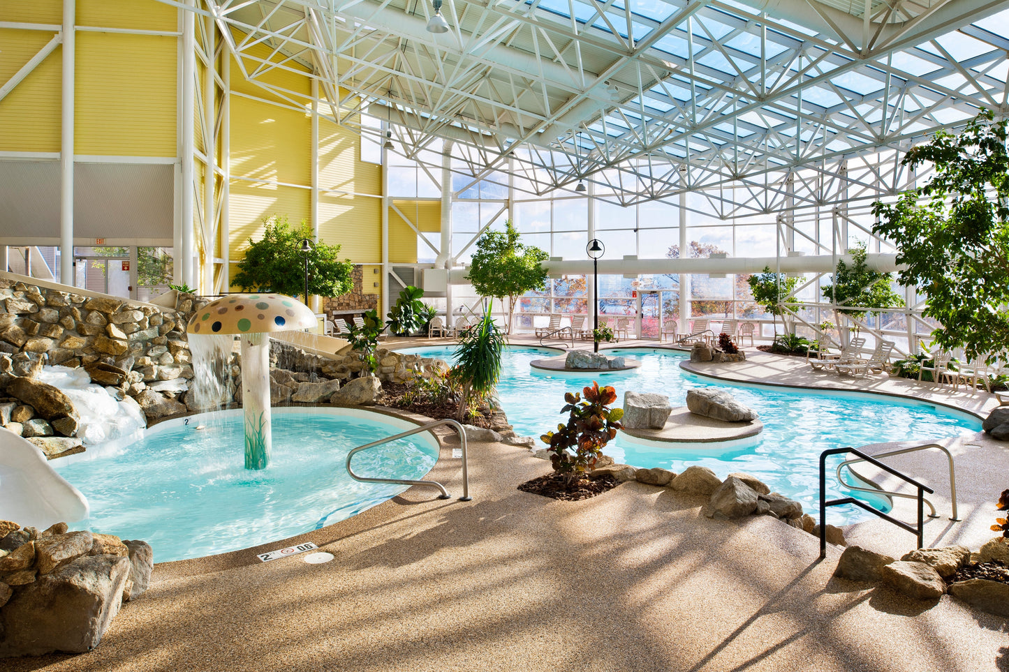 Steele Hill's indoor atrium pool with a mushroom fountain, waterslide and rock waterfall